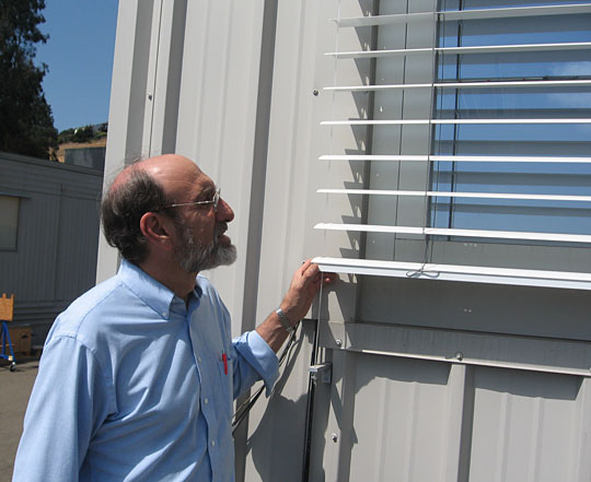 Steve Selkowitz examines the shutters at the Window Lab at The Lawrence Berkley National Labratory.