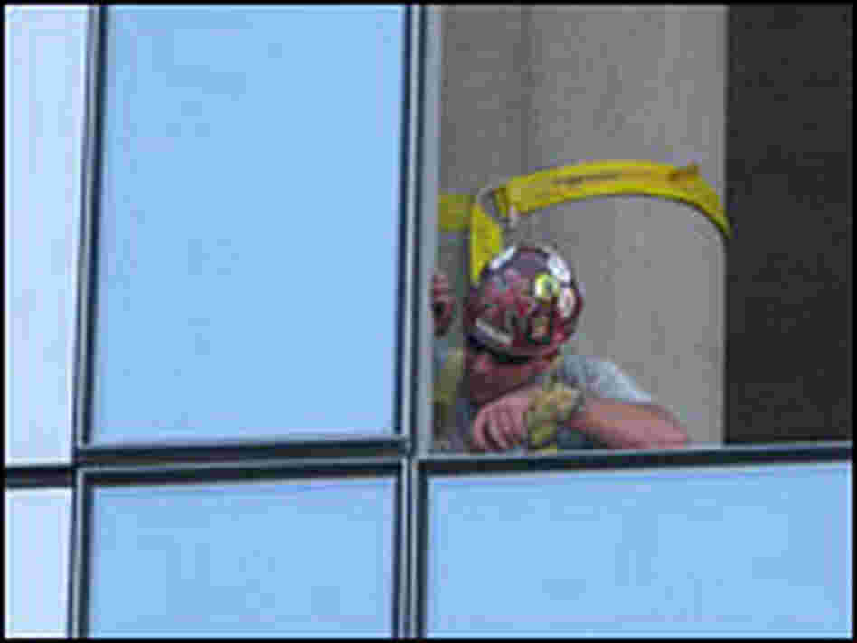 An energy efficient glass panel being fitted into a downtown Portland building.