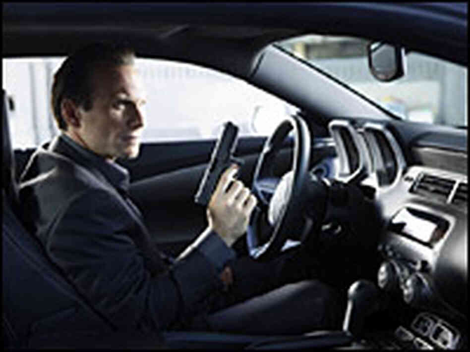 Christian Slater in the driver's seat with a gun