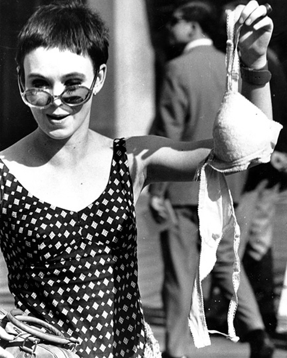 An unidentified member of the Women's Liberation Party drops a brassiere in the trash