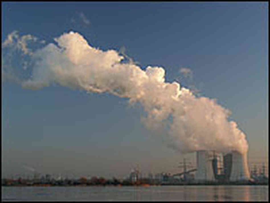 A power plant emits gases over a lake A power plant emits gases over a lake