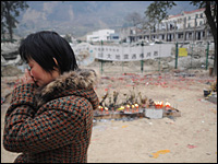 Nearly a year after a massive earthquake devastated southwestern China, the government has yet to release the death toll of children killed in collapsing schools. Here, a woman mourns her dead child at the ruins of a middle school in Beichuan county in China's Sichuan province on Jan. 25.