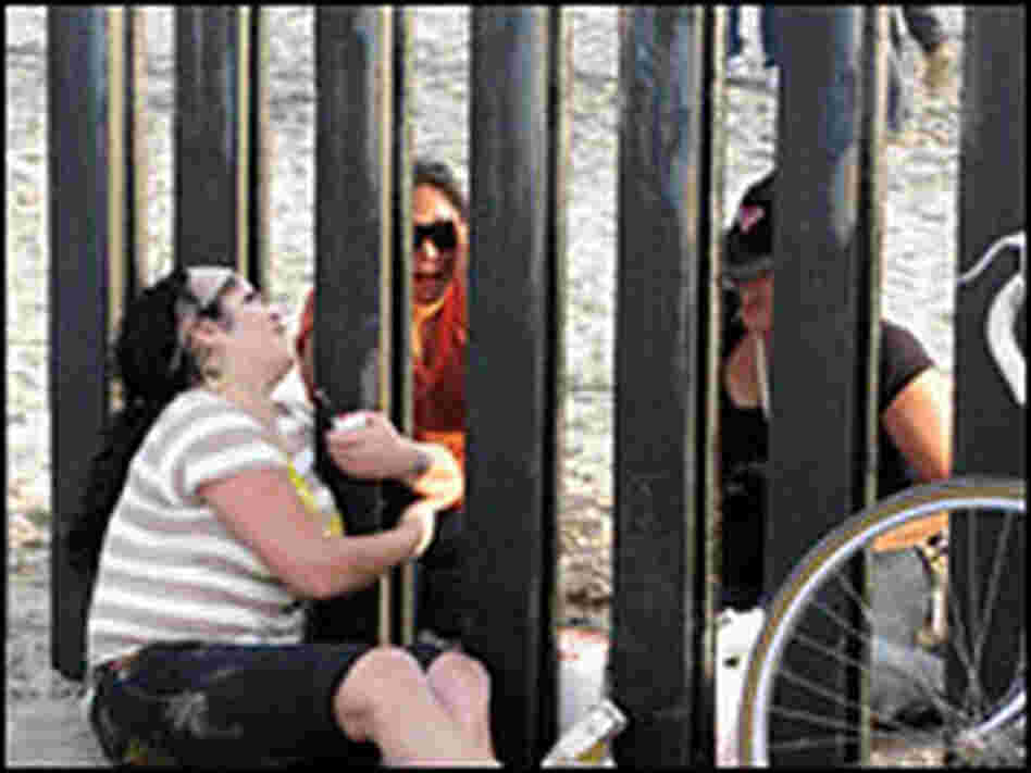 Friends and families meet on either side of the border.