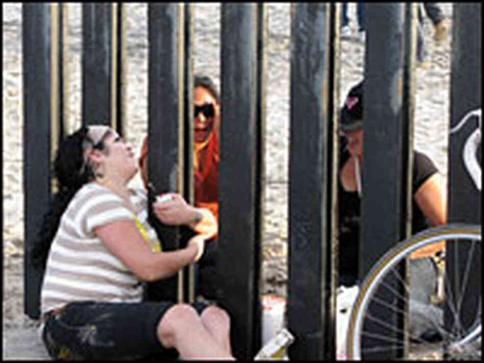 Friends and families meet on either side of the border.