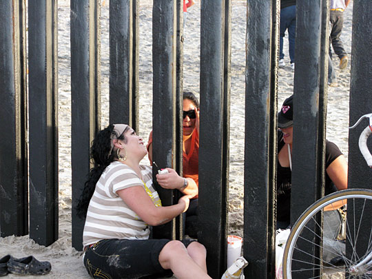 Friends and families meet on either side of the border.
