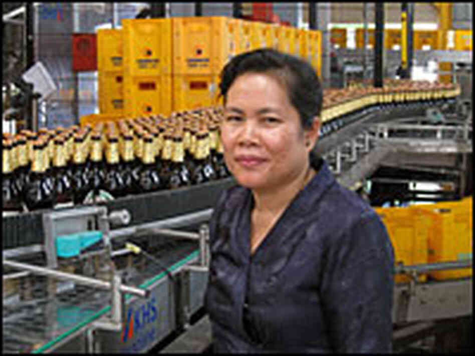 Brewmaster Sivilay Lasachack stands beside a bottling line at the Beer Lao plant outside Vientiane