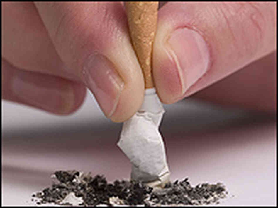 A person putting out a cigarette. A person putting out a cigarette.