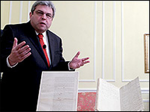 Marvin Pinkert, executive director of the National Archives Experience, displays several original documents regarding the presidential oath of office.
