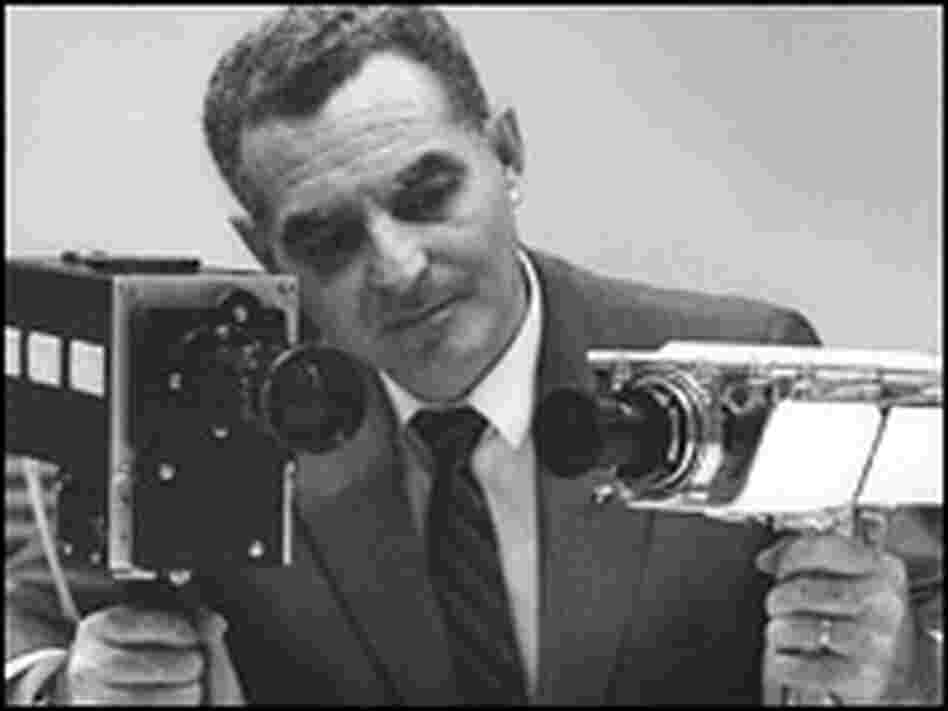 Stan Lebar holds the two cameras he helped design for the Apollo 11 mission.