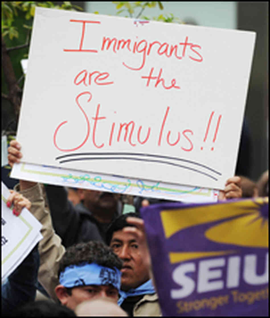 Protesters hold signs at a rally for universal health care reform