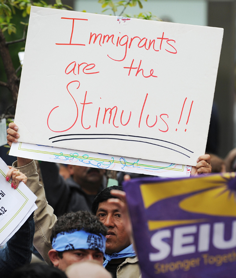 Protesters hold signs at a rally for universal health care reform