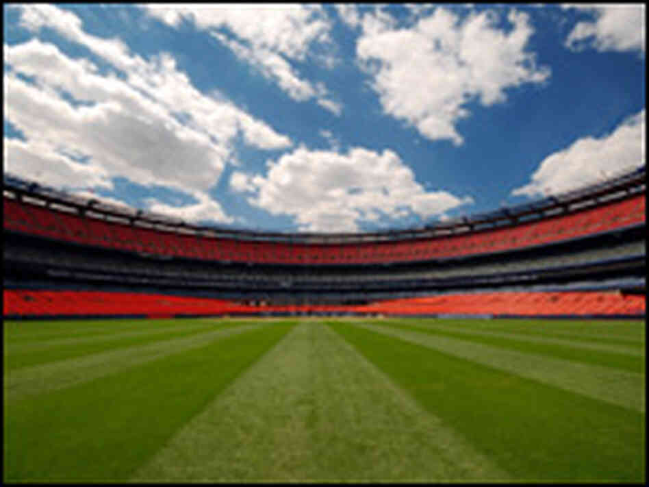 An empty baseball stadium from the outfield An empty baseball stadium from the outfield