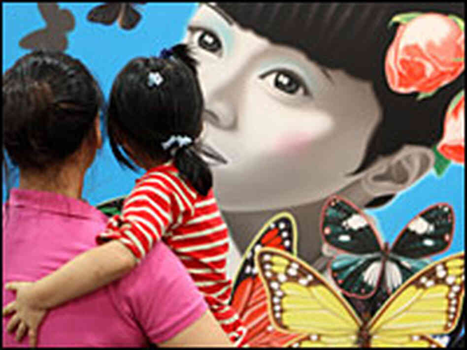 Visitors admire artwork on display at the SH contemporary art fair