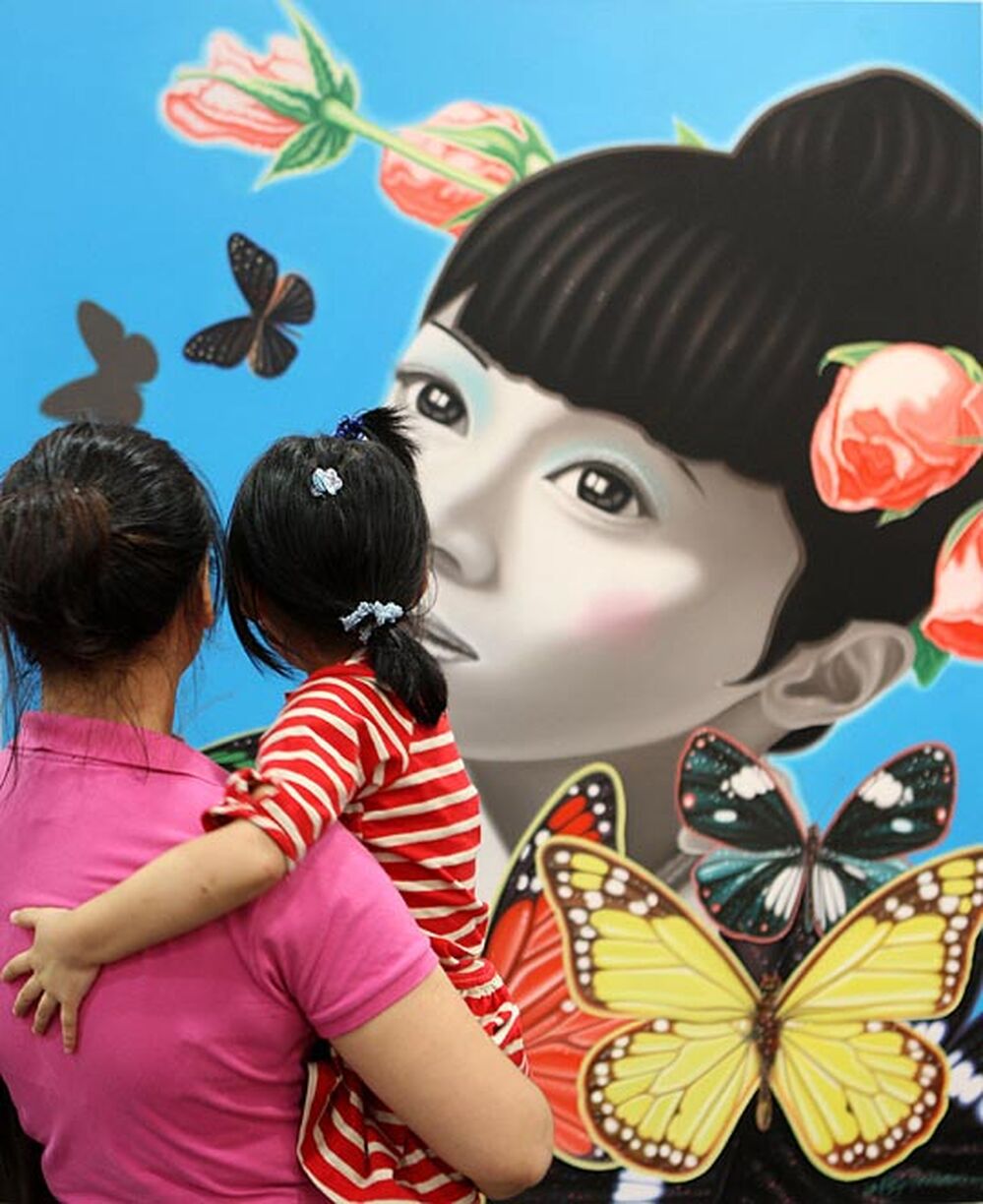 Visitors admire artwork on display at the SH contemporary art fair