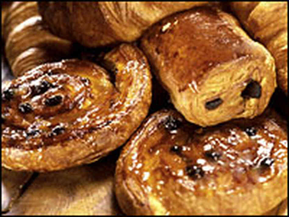 A plate of croissant and danish. A plate of croissant and danish.