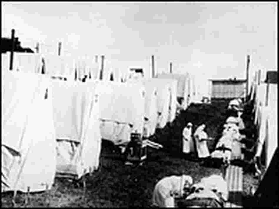 Nurses care for 1918 Spanish flu patients in tents.