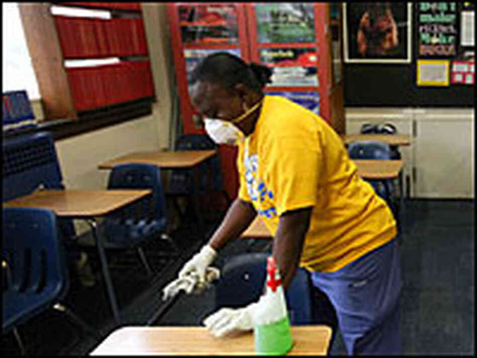 Fort Worth Independent school district custodian Necie Homer wipes down a classroom with disinfectan