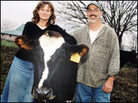 Debbie and Mark Apple, pictured with one of their milk cows. Debbie and Mark Apple, pictured with one of their milk cows.
