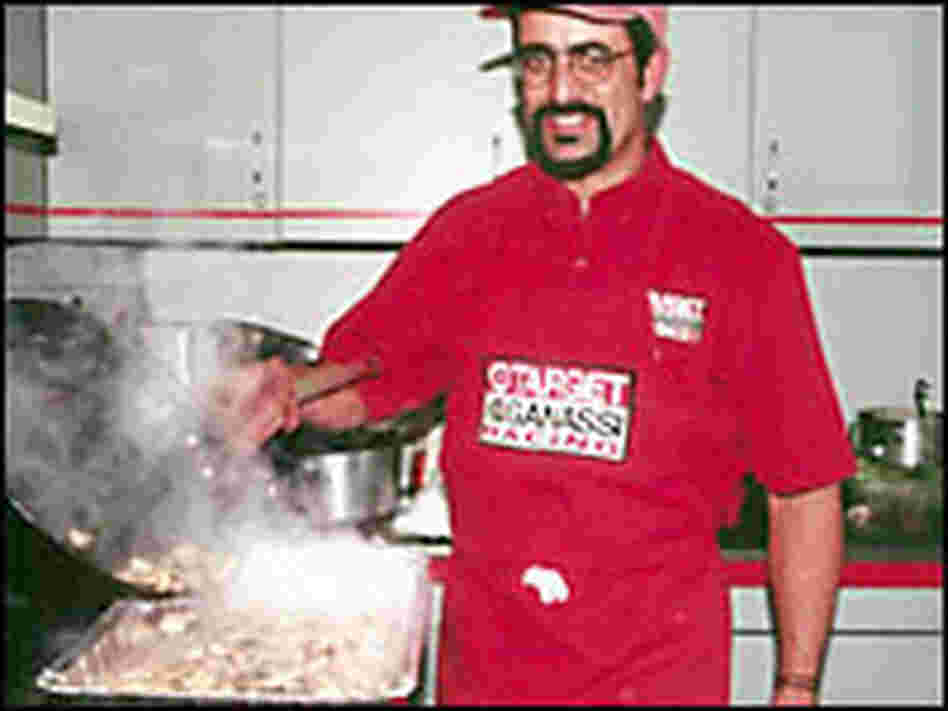 Public radio listener John Wheeler, in his hidden kitchen, cooks for the team. Public radio listener John Wheeler, in his hidden kitchen, cooks for the team.