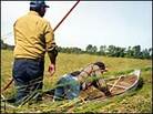 Two members of the Ojibwe tribe in a canoe venture into tall grasses to harvest wild rice. Two members of the Ojibwe tribe in a canoe venture into tall grasses to harvest wild rice.