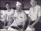 Men wrap beef in cheesecloth at a sheriff's barbecue in Los Angeles. Men wrap beef in cheesecloth at a sheriff's barbecue in Los Angeles.