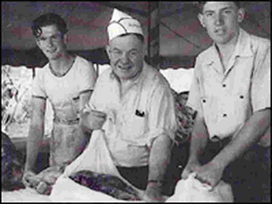 Men wrap beef in cheesecloth at a sheriff's barbecue in Los Angeles. Men wrap beef in cheesecloth at a sheriff's barbecue in Los Angeles.