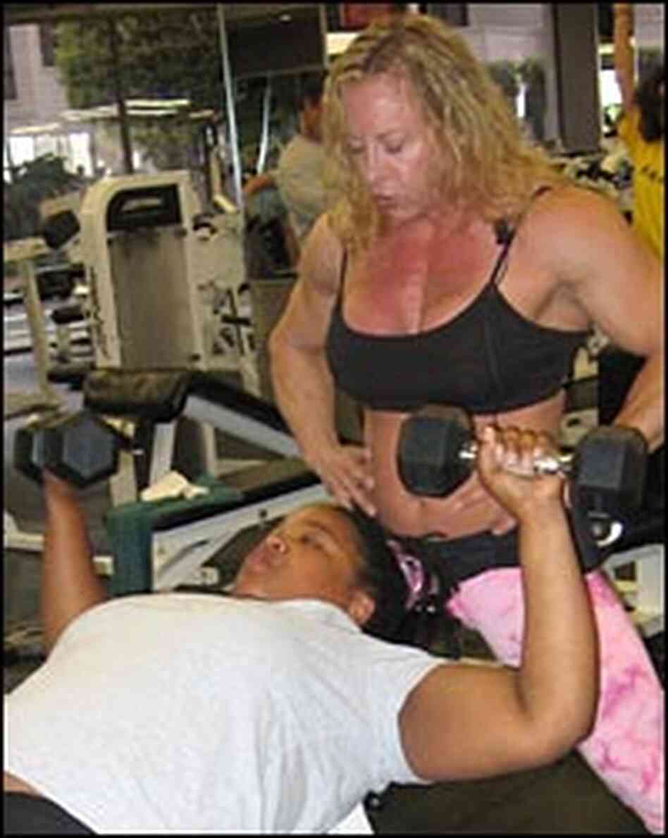 Solomons coaches Chideya on the proper method for using dumbbells. Solomons coaches Chideya on the proper method for using dumbbells.