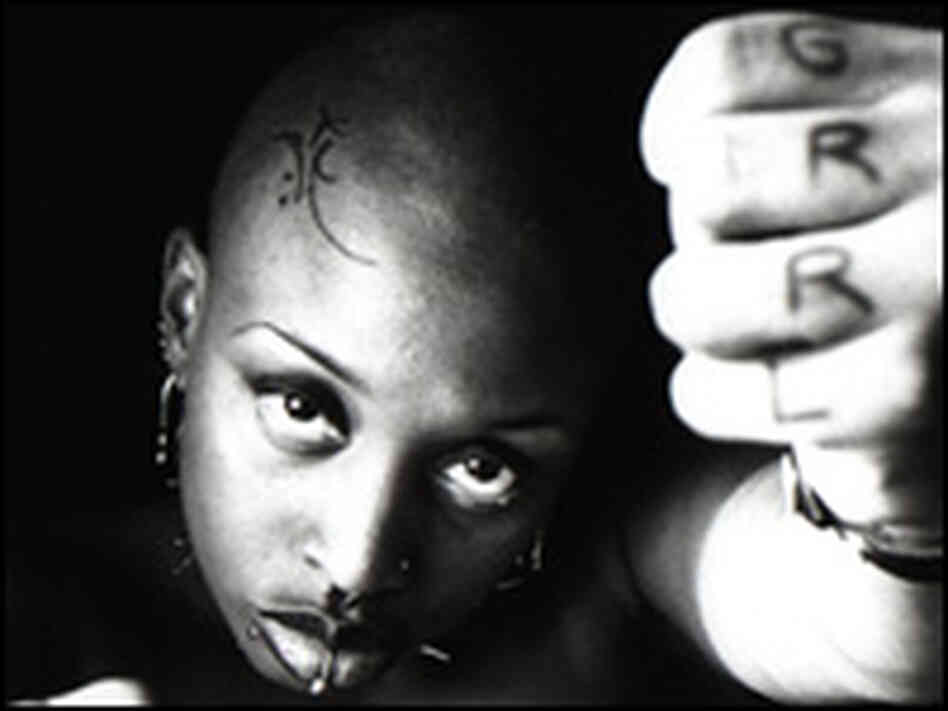 Tamar-kali, in a very dark shot showing her forehead tattoo, nose piercing.