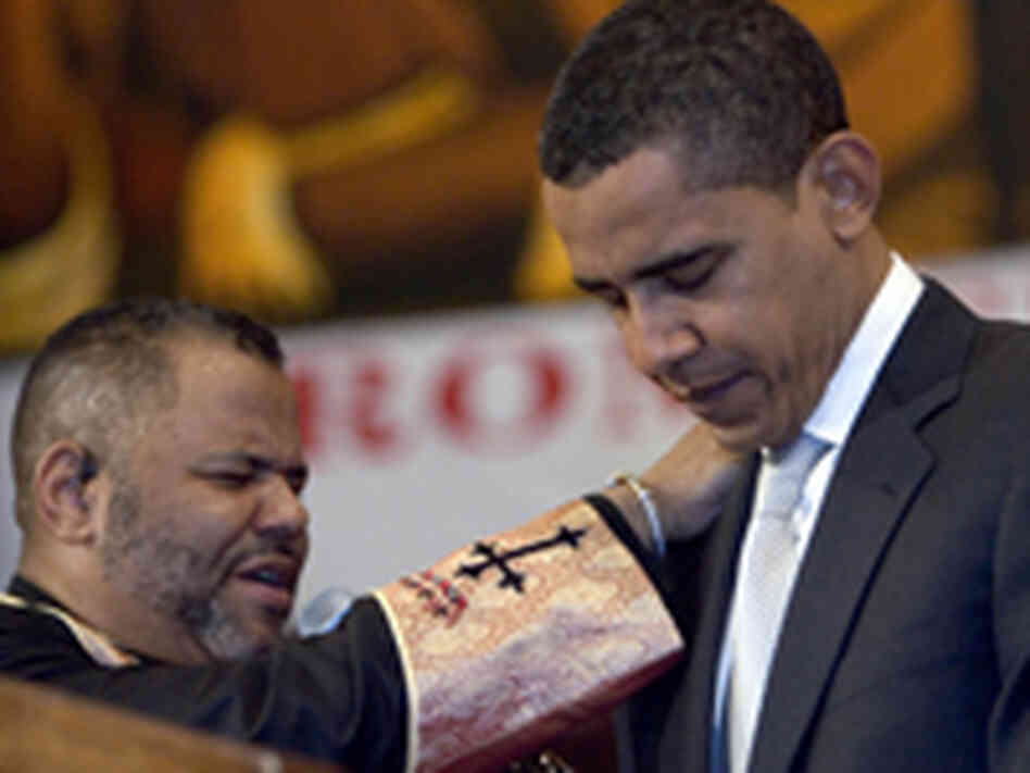 Senior Minister John J. Hunter (left) prays for Barack Obama Senior Minister John J. Hunter (left) prays for Barack Obama