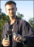 Chris Valligny holds a scrub-jay.