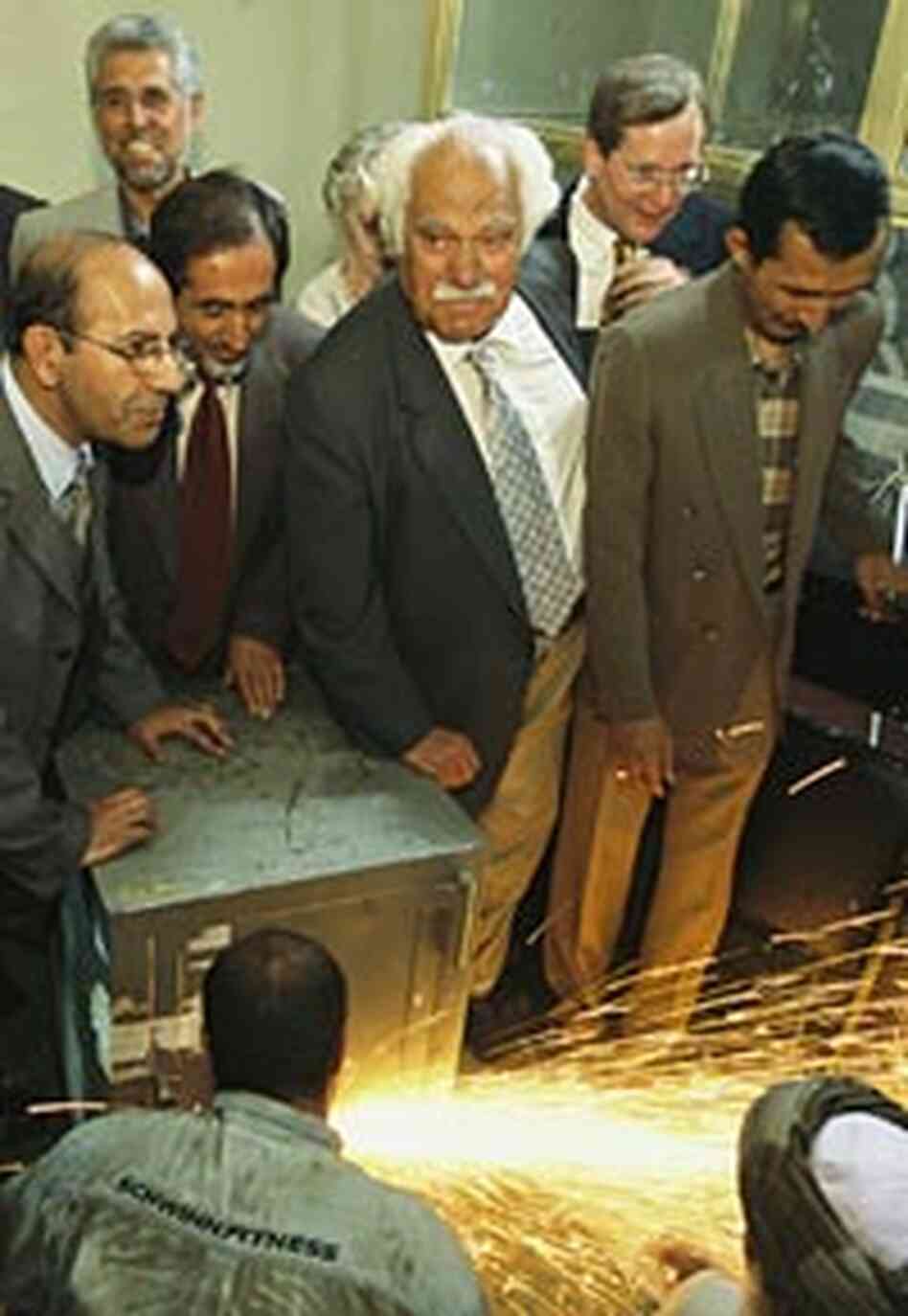 Fredrik Hiebert, second from right, watches with Afghan officials watches as a safe is forced open Fredrik Hiebert, second from right, watches with Afghan officials watches as a safe is forced open