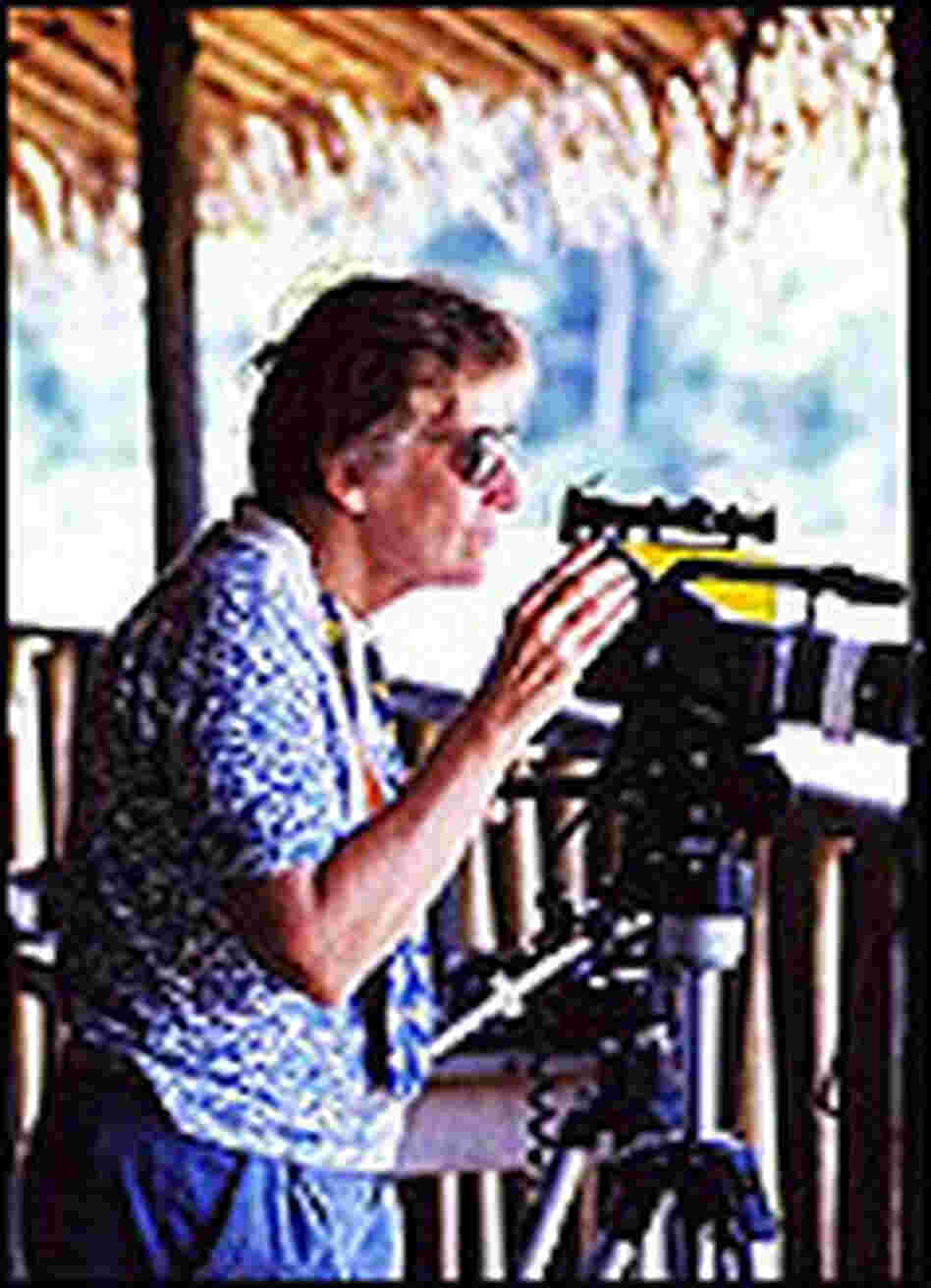 Researcher Katy Payne uses a long lense to look out onto the elephant bai. Researcher Katy Payne uses a long lense to look out onto the elephant bai.