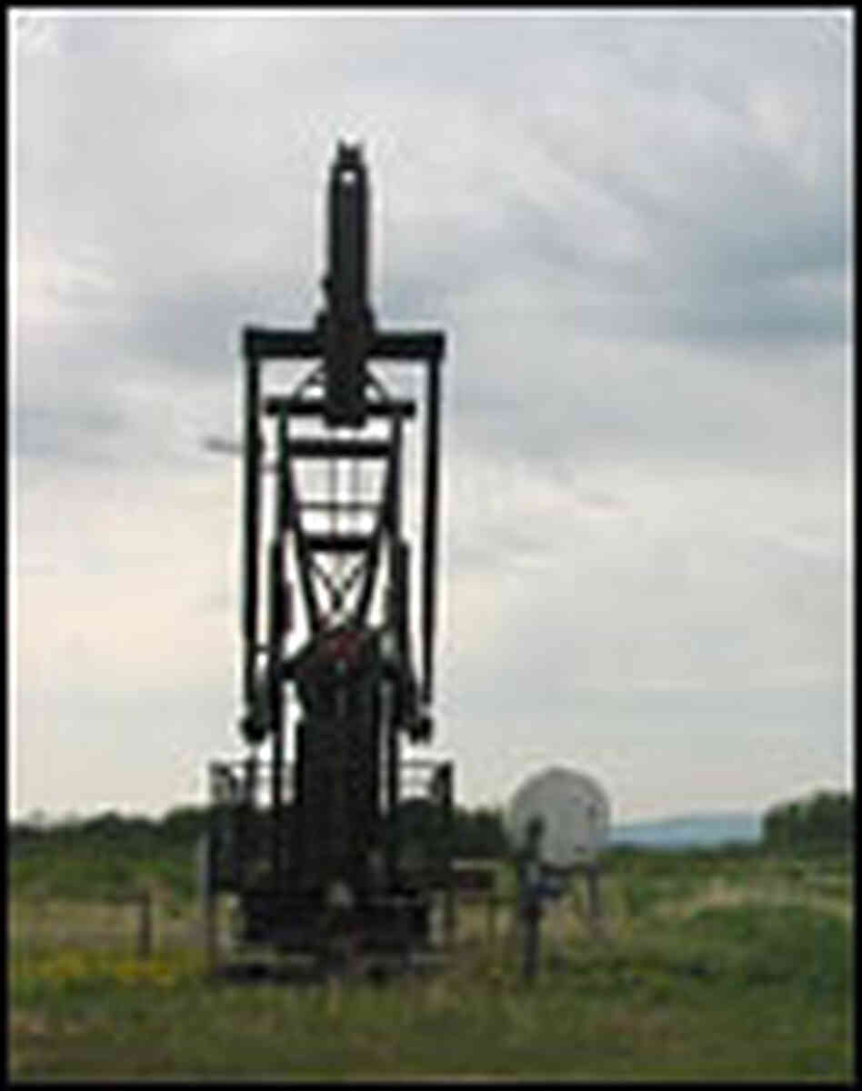 An oil well in an open field An oil well in an open field