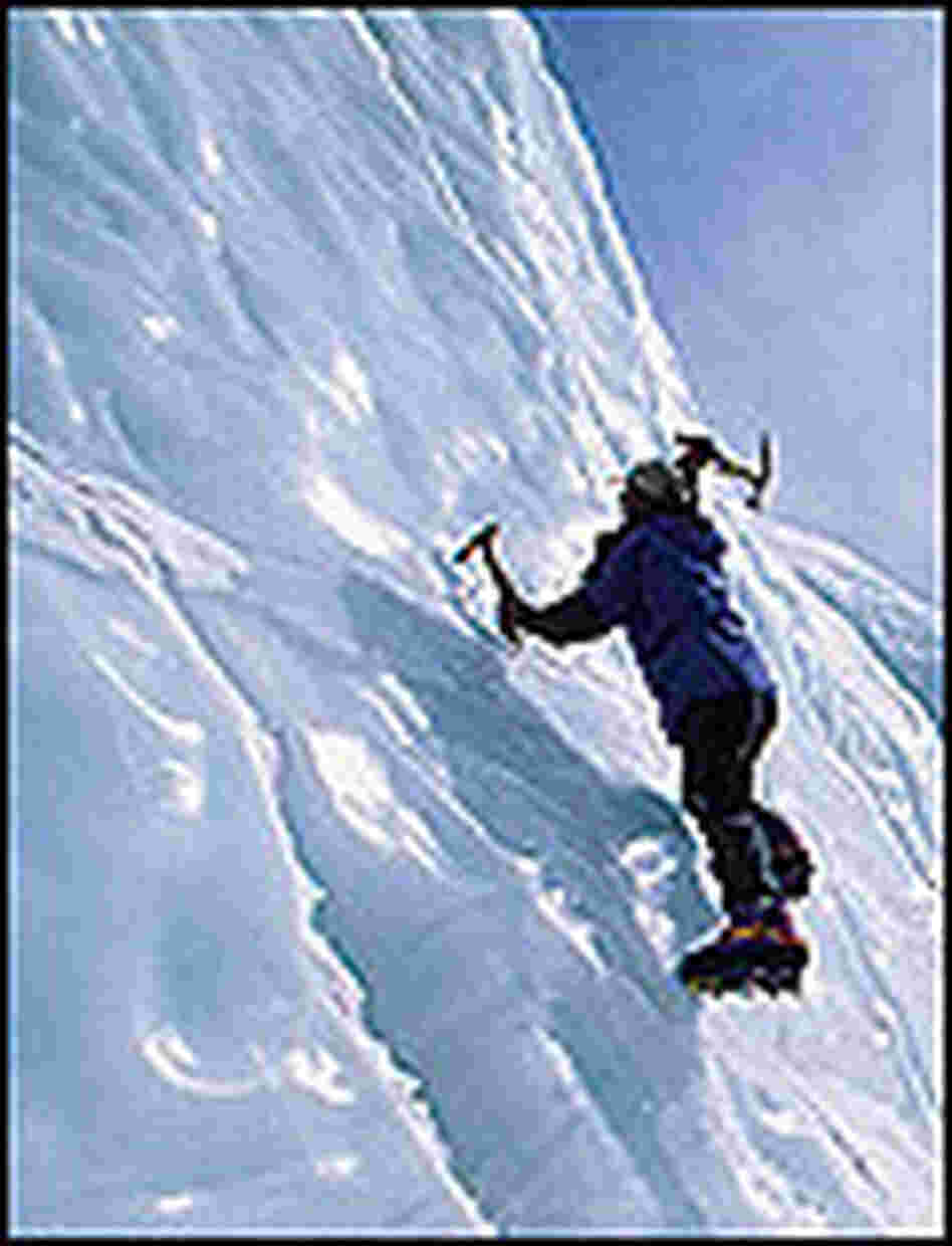 Jamling Norgay swings an ice pick as he climbs a nearly vertical ice wall. Jamling Norgay swings an ice pick as he climbs a nearly vertical ice wall.