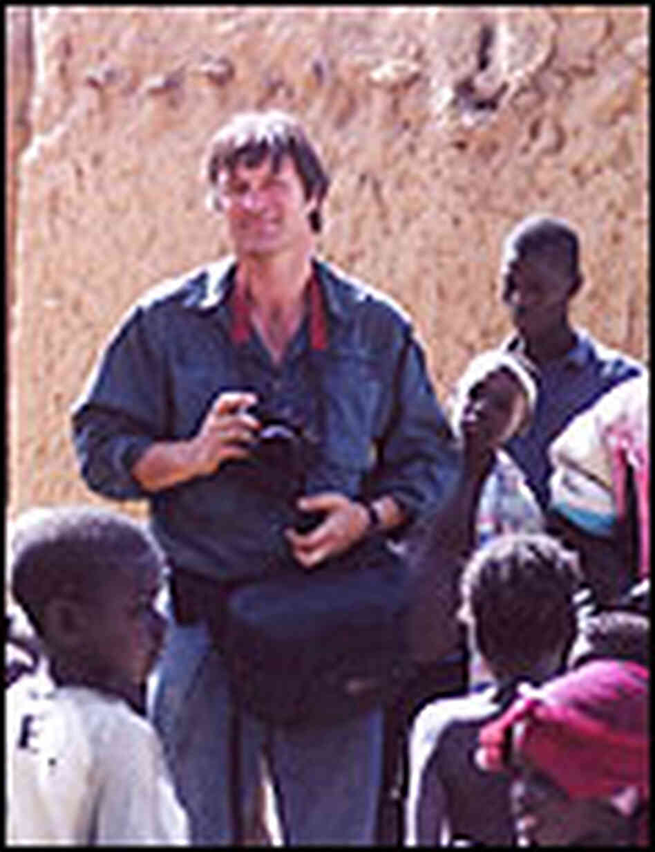 Photographer Chris Rainier in Djenne, Mali, with a group of local children. Photographer Chris Rainier in Djenne, Mali, with a group of local children.