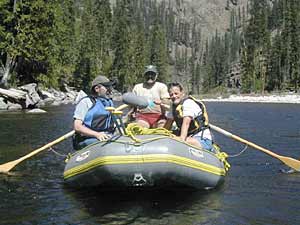 NPR's Elizabeth Arnold, NPR engineer Bill McQuay 
		and river ranger Barry Williams in an inflatable boat on the Selway River