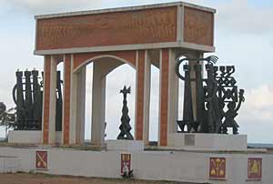 An arch with metal sculptures on either side that is meant to recall Africans sent into slavery