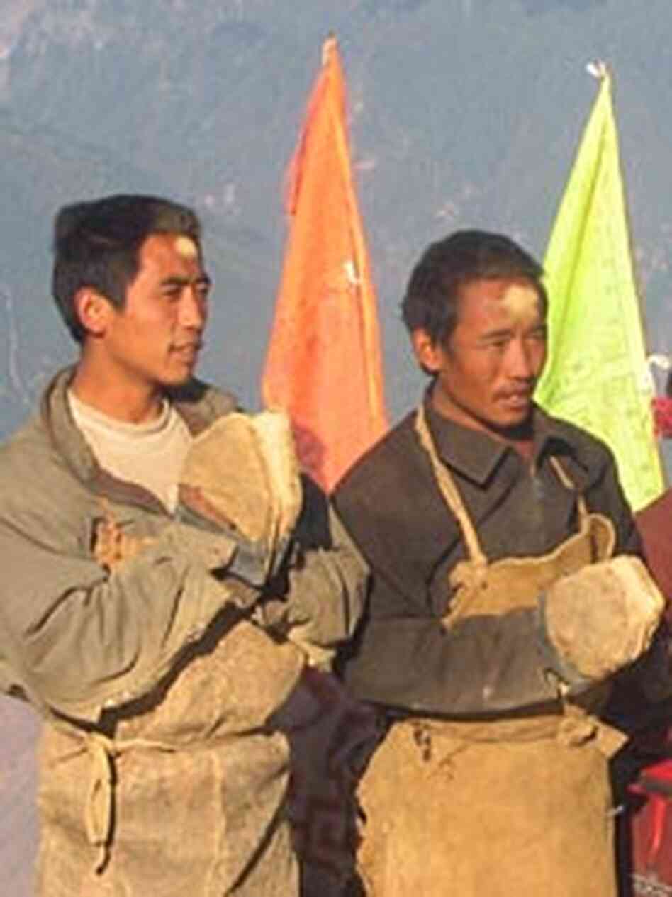 Buddhist pilgrims on the trail circling the sacred peak of Kawakarpo beg for alms. Buddhist pilgrims on the trail circling the sacred peak of Kawakarpo beg for alms.