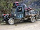 A customized truck on the winding mountain roads of Yunnan Province. A customized truck on the winding mountain roads of Yunnan Province.