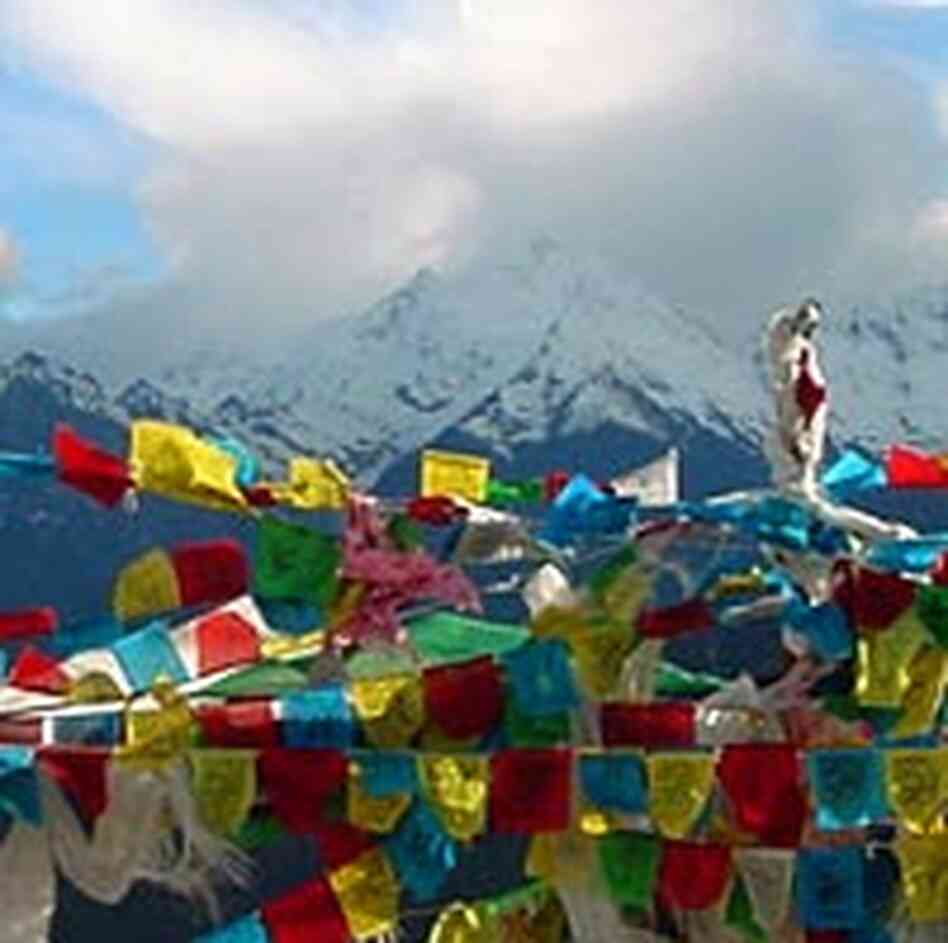 A view of Kawakarpo from Baima Pass, with prayer flags in the foreground.