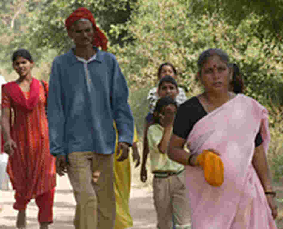 Pilgrims walk barefoot in the soft dust paths linking holy sites in and around the city of Vrindavan