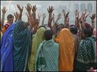 Hindu faithful gather on the river's shore to sing around an impromptu altar to Krishna. Hindu faithful gather on the river's shore to sing around an impromptu altar to Krishna.