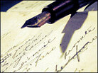 Fountain pen poised over handwriting.