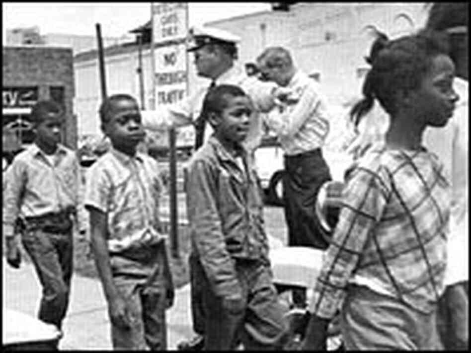 Policemen lead school children to jail for protesting discrimination in Birmingham, Ala., 1963. Policemen lead school children to jail for protesting discrimination in Birmingham, Ala., 1963.