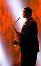 Victor Goines holds on to his tenor sax during an summer 2003 outdoor concert. Victor Goines holds on to his tenor sax during an summer 2003 outdoor concert.