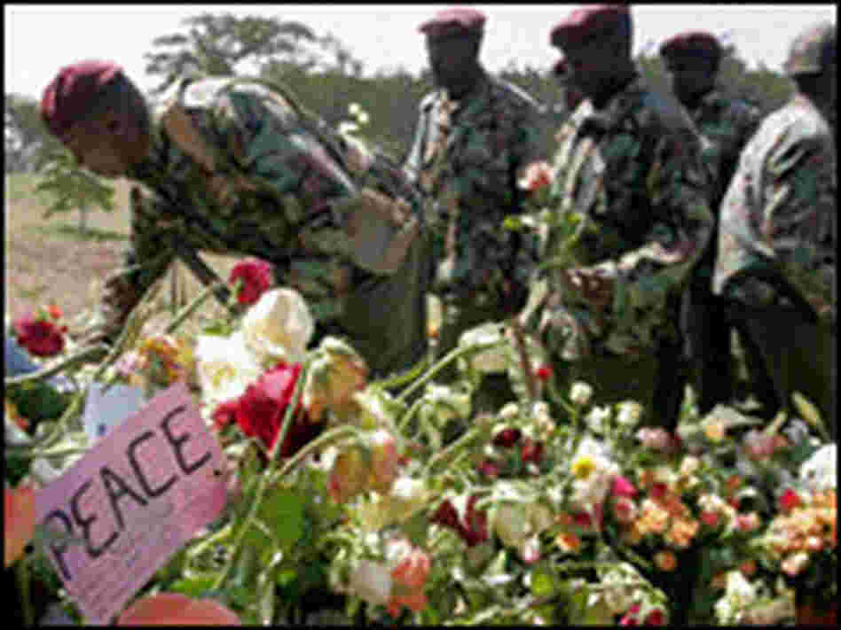 Kenyan police visit a memorial for those killed in post-election violence. Kenyan police visit a memorial for those killed in post-election violence.