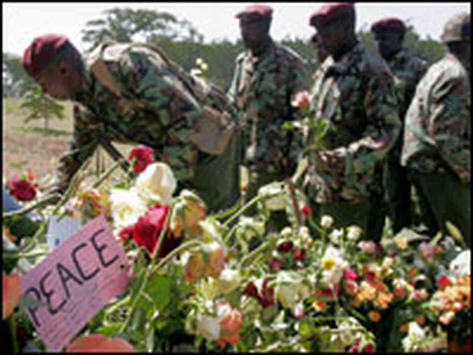 Kenyan police visit a memorial for those killed in post-election violence. Kenyan police visit a memorial for those killed in post-election violence.