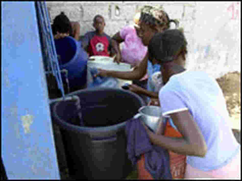 Haitians get water. THONY BELIZAIRE/AFP/Getty Images. Haitians get water. THONY BELIZAIRE/AFP/Getty Images.