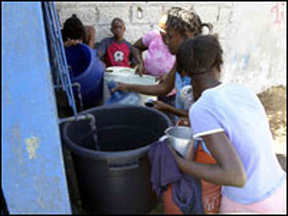 Haitians get water. THONY BELIZAIRE/AFP/Getty Images. Haitians get water. THONY BELIZAIRE/AFP/Getty Images.