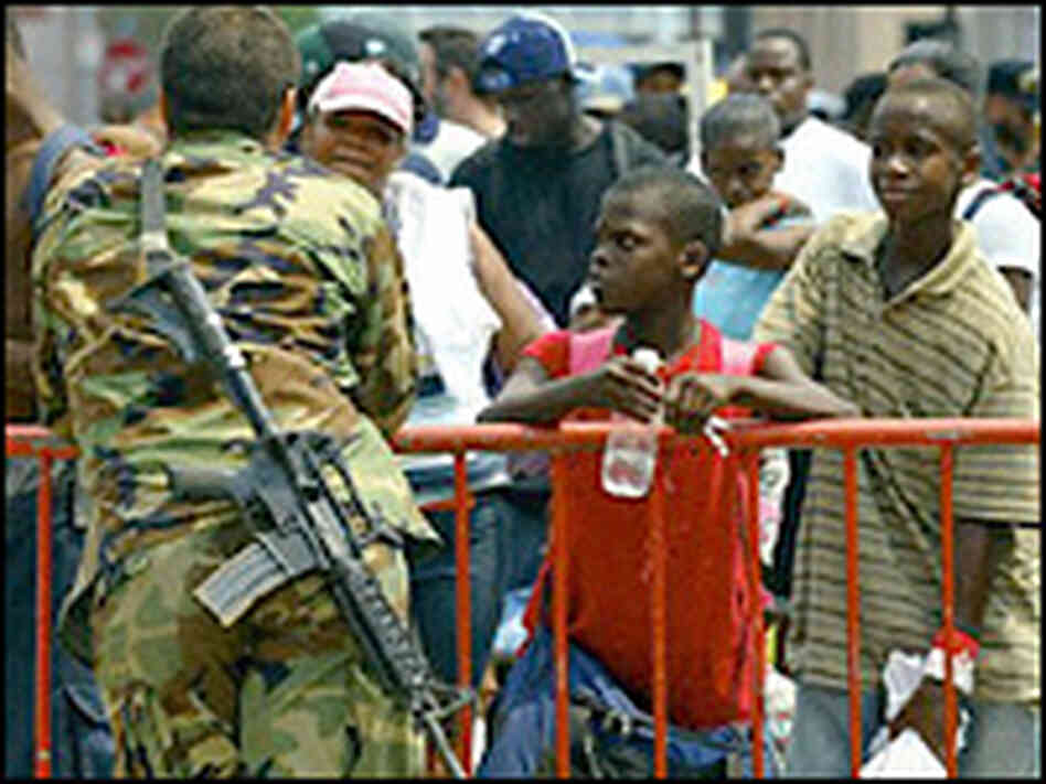 New Orleans residents wait in line to be evacuated from the Convention Center area in New Orleans, S New Orleans residents wait in line to be evacuated from the Convention Center area in New Orleans, S